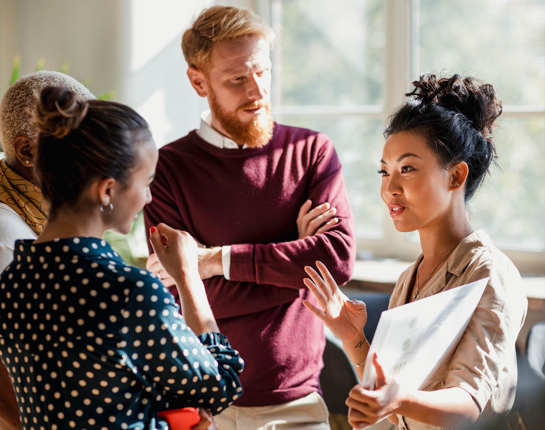 Mixed group talking in office